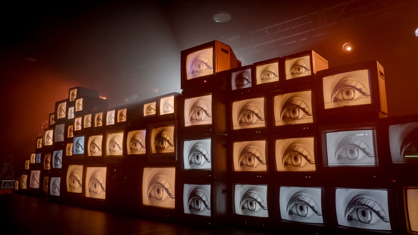 A series of CRT TV screens, stacked on top each other on the stage at the Beat The System after party.
