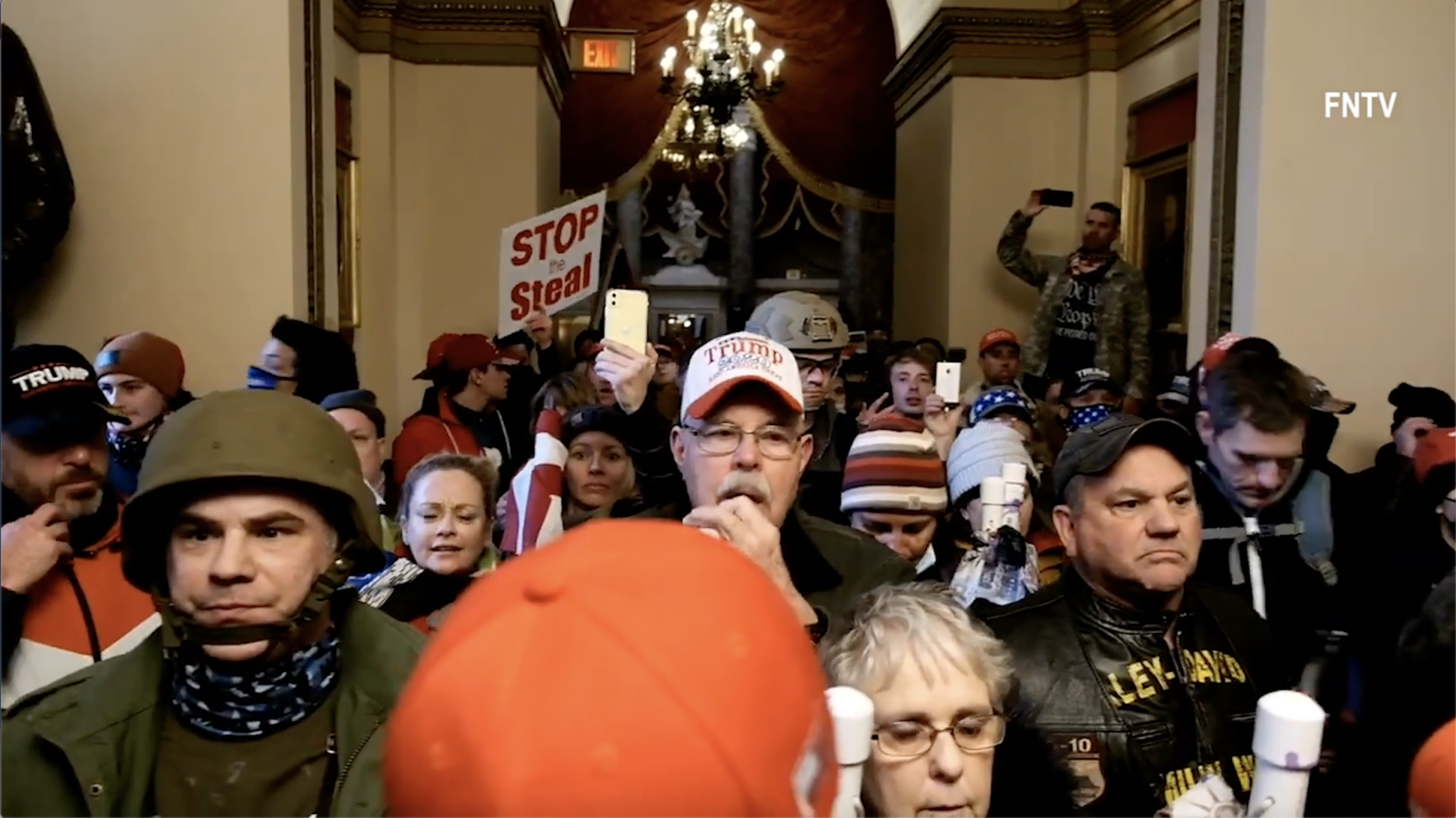 A still from INSURRECTION, a film by Andres Serrano. The still features Trump supporters gathering inside Capitol Hill.