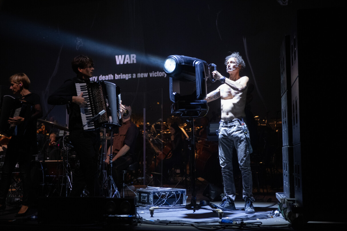 Screenshot from the performance of Alamut by Laibach in Ljubljana, Slovenia. This image depicts a lighting engineer using a full beam light to target the audience.